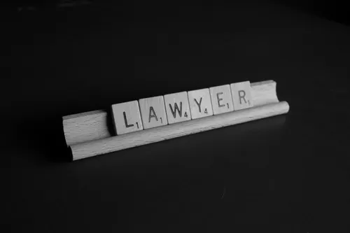 Scrabble letters that spell out LAWYER