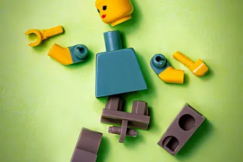 Lego person with pieces that need connected to make a doll