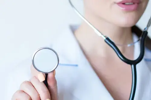 Female doctor in lab coat with a stethoscope.